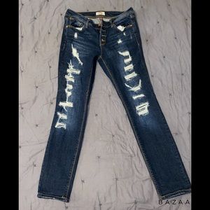 Ripped regular jeans with buttons as zipper